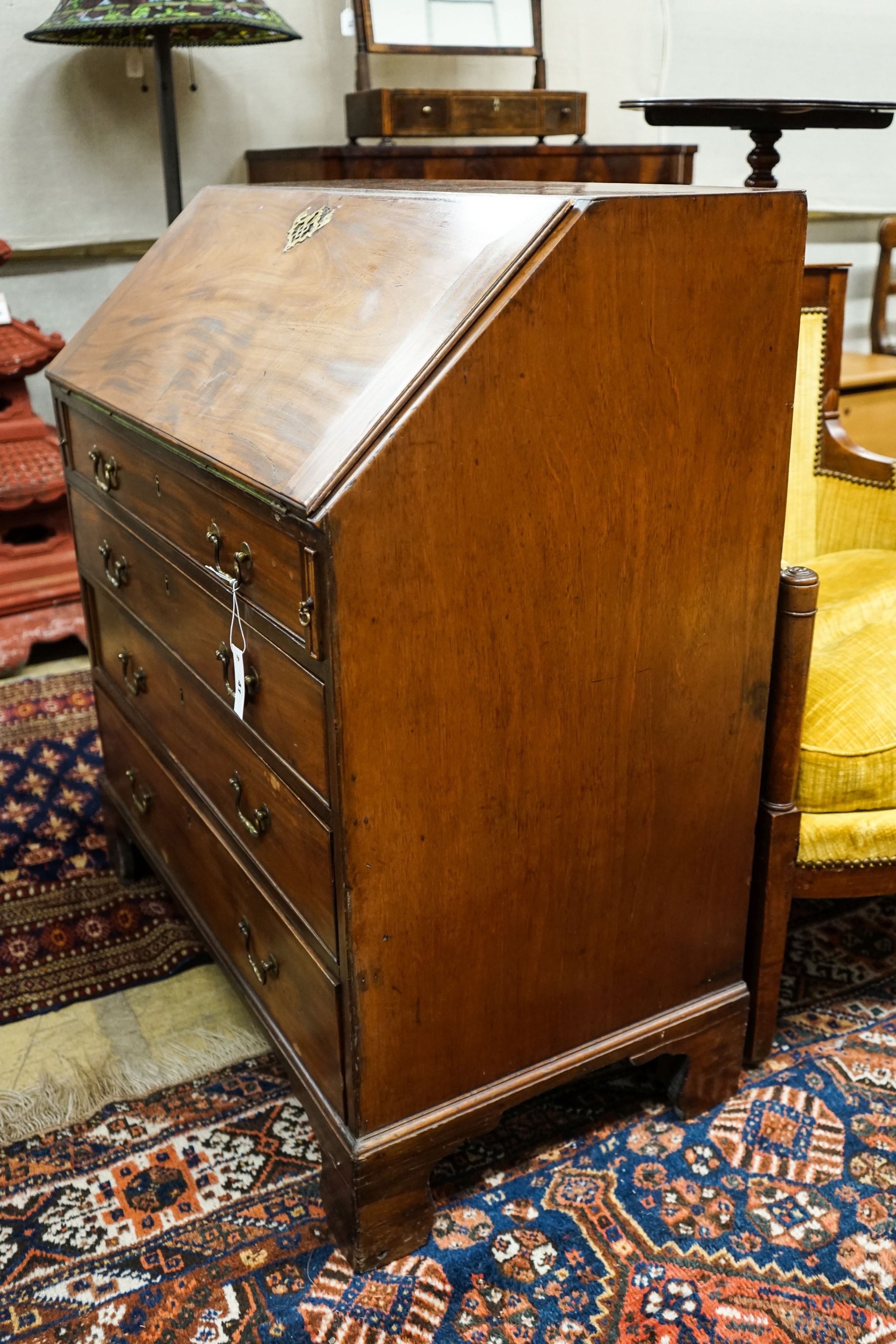 A George III mahogany bureau, with fall front and four drawers, width 91cm, depth 50cm, height 102cm